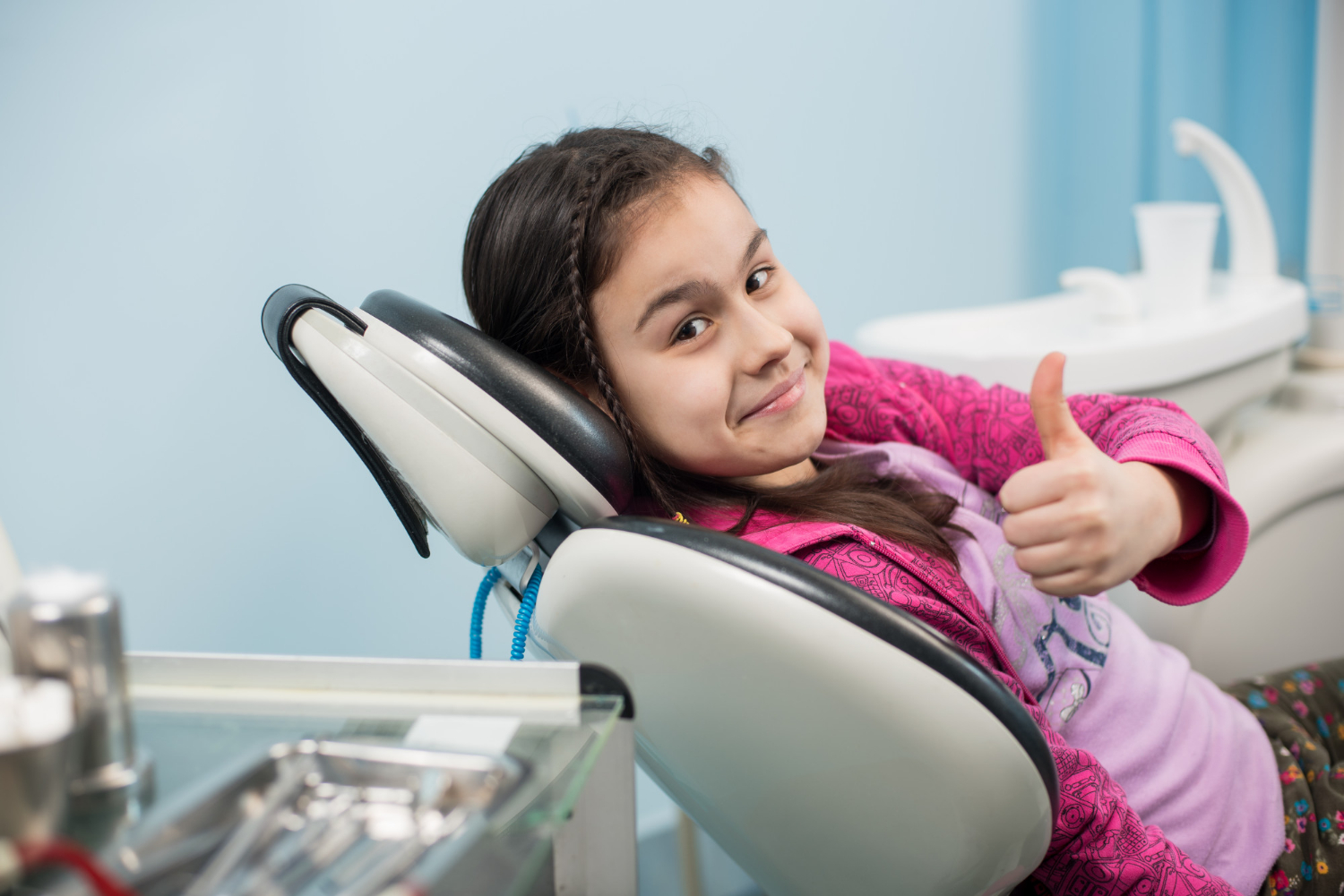atient-girl-showing-thumbs-up-dental-office