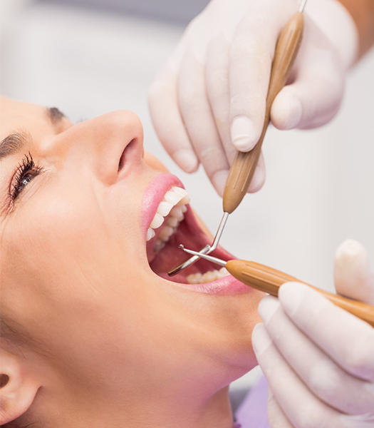 dentist-examining-female-patient-teeth