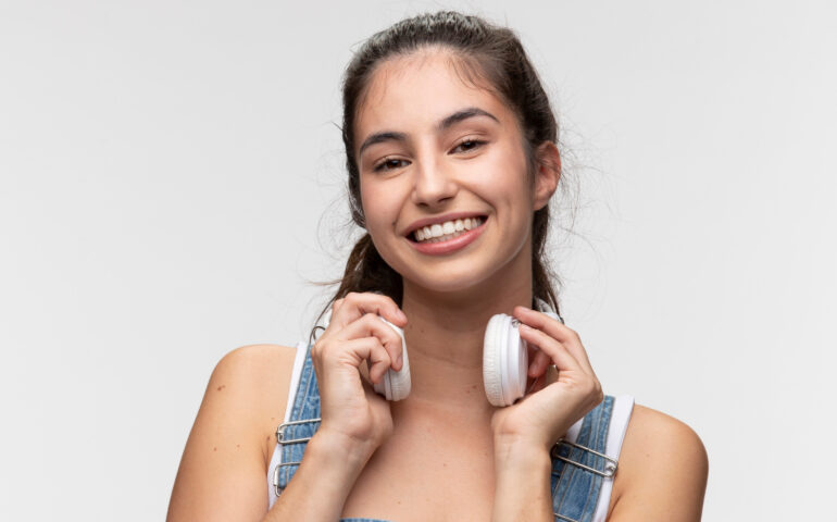 portrait-young-teenage-girl-overalls-listening-music-headphones